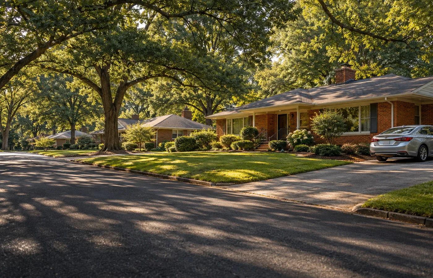 Representative Tucker Georgia leafy residential street with warm brick ranch homes and a car on a driveway.